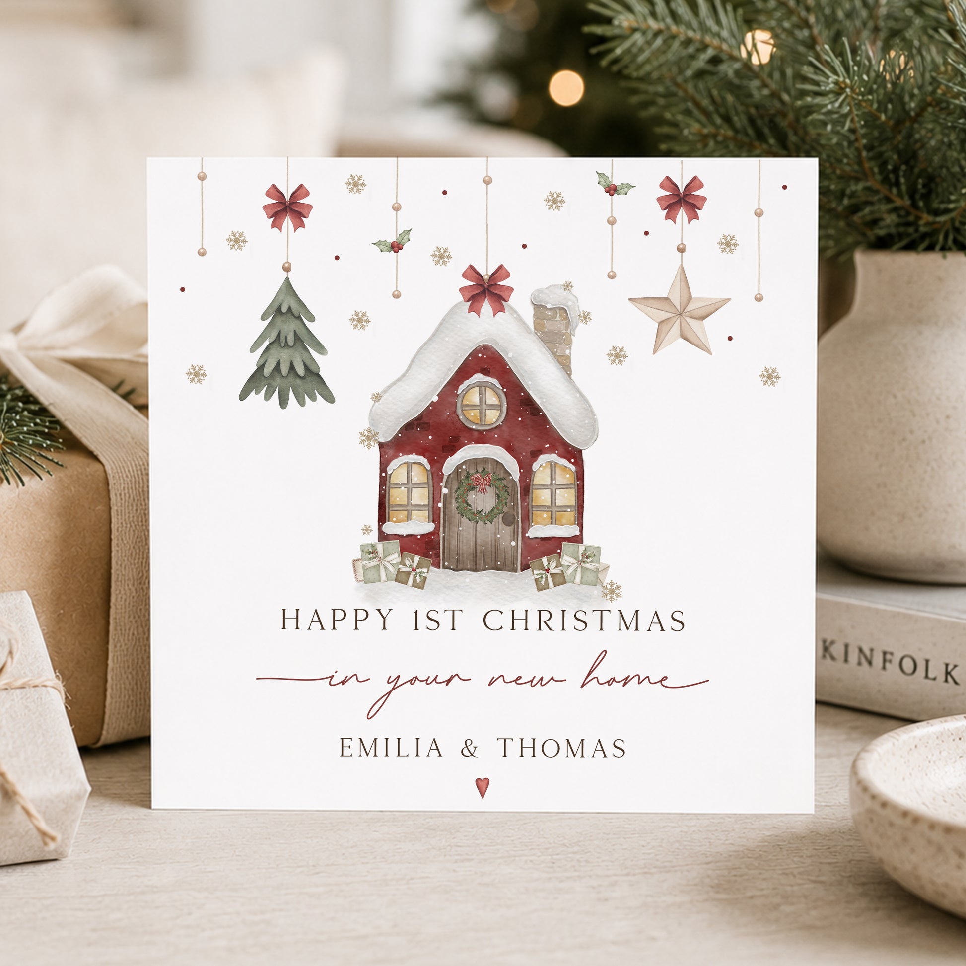 Personalised First Christmas in new home card with festive red house, Christmas tree and presents, customised with names.