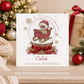 Personalised Grandson First Christmas card featuring a teddy bear in a red sleigh inside a Christmas snow globe, with red bow, berries and gold snowflakes. Personalised with a name and relation and also suitable for Son, Nephew or Godson.