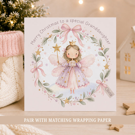 Personalised Granddaughter Christmas card featuring a pink and lilac Nutcracker fairy surrounded by a festive wreath with bows, stars and greenery.