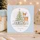 Personalised baby boy First Christmas card featuring a reindeer with blue bow, snowy Christmas tree, snowflakes and 2026, with name and relation.