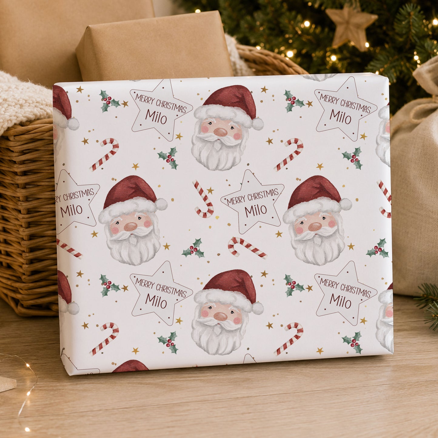 Personalised Santa Christmas wrapping paper featuring Santa faces, candy canes, holly and stars with the child’s name.