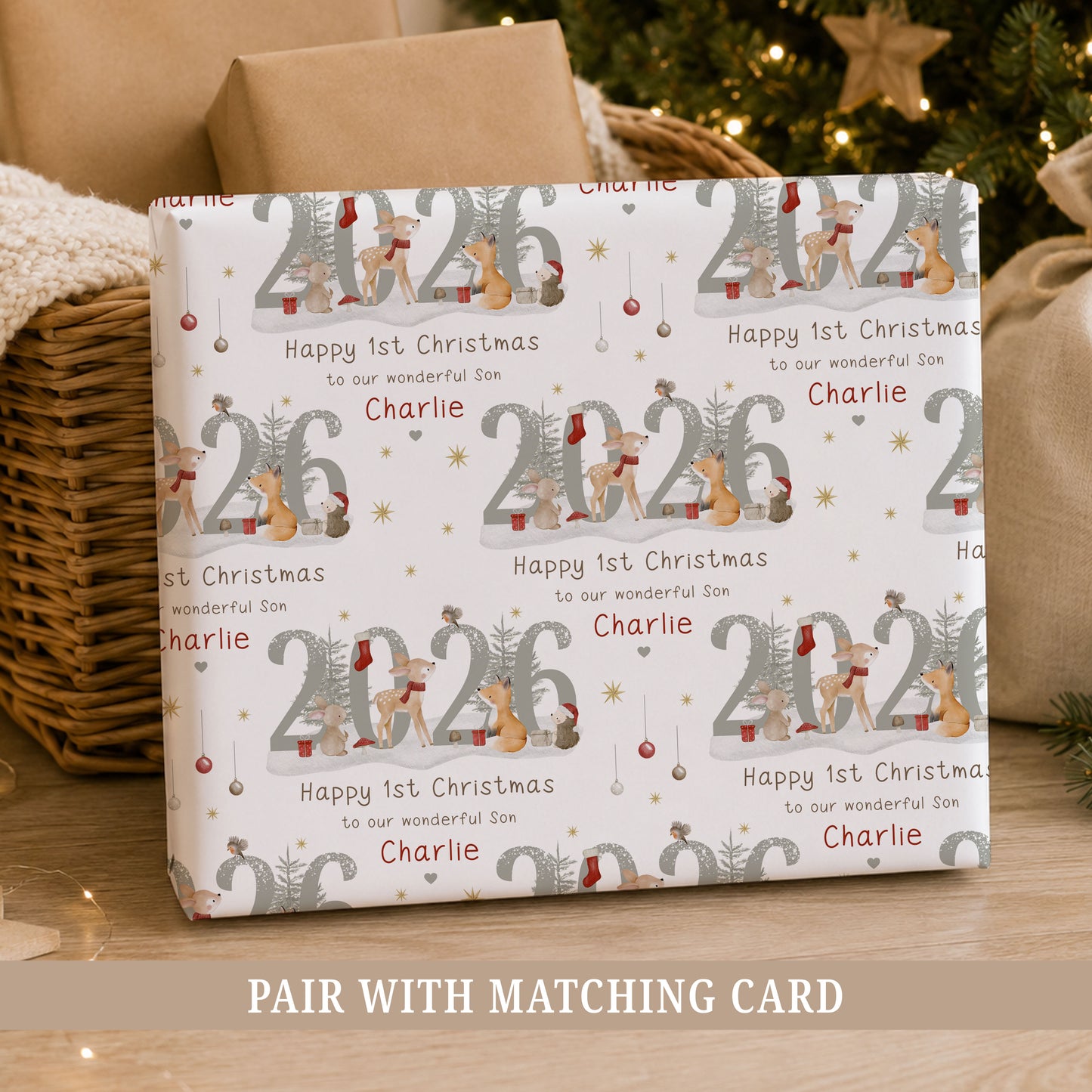 Personalised Son First Christmas wrapping paper featuring woodland animals, 2026 design and the child’s name in a festive repeating pattern.