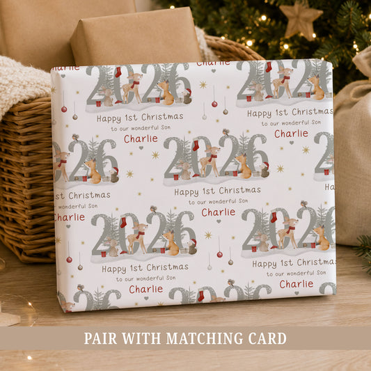 Personalised Son First Christmas wrapping paper featuring woodland animals, 2026 design and the child’s name in a festive repeating pattern.