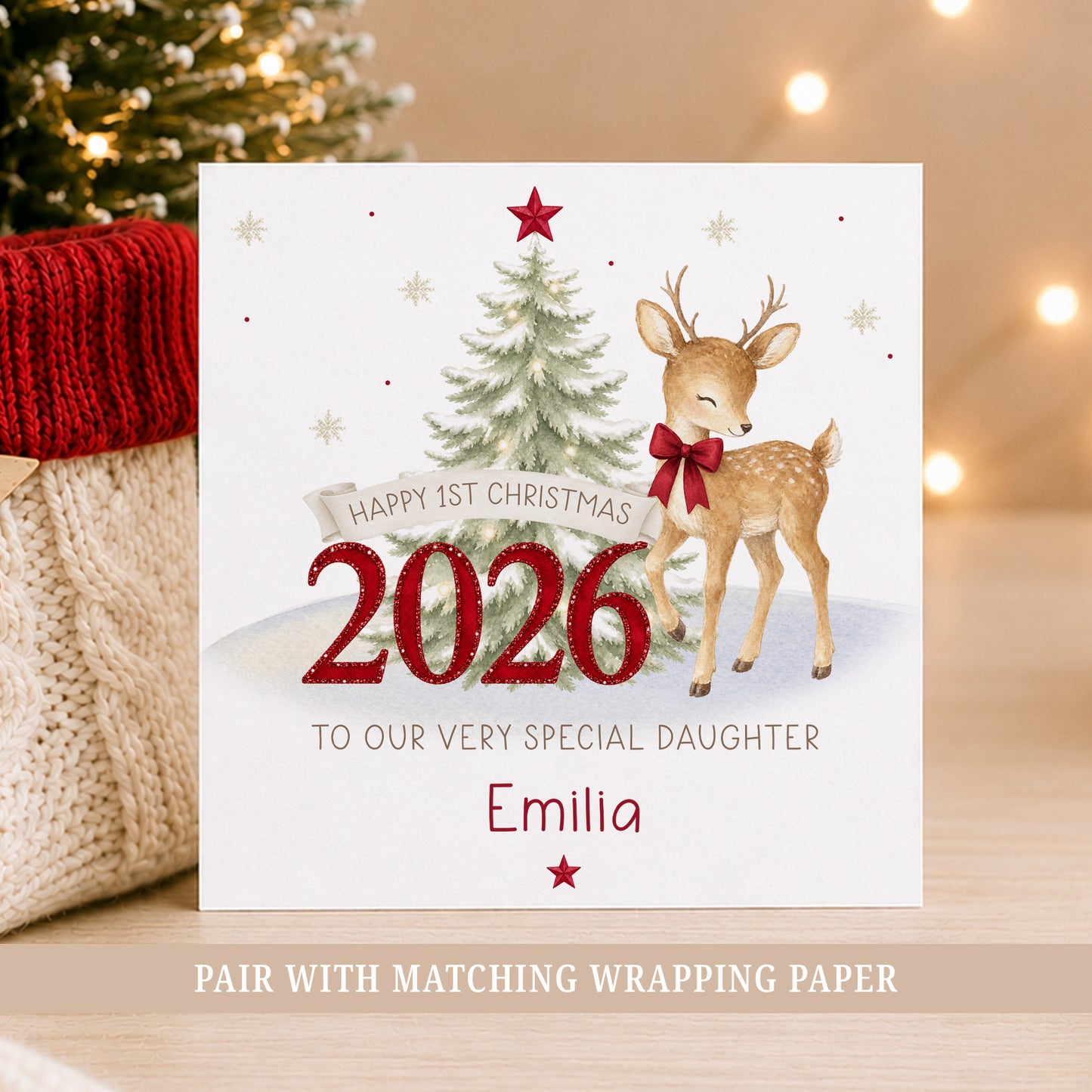 Personalised First Christmas card featuring a reindeer with red bow, snowy Christmas tree, red 2026 numbers, stars and snowflakes.