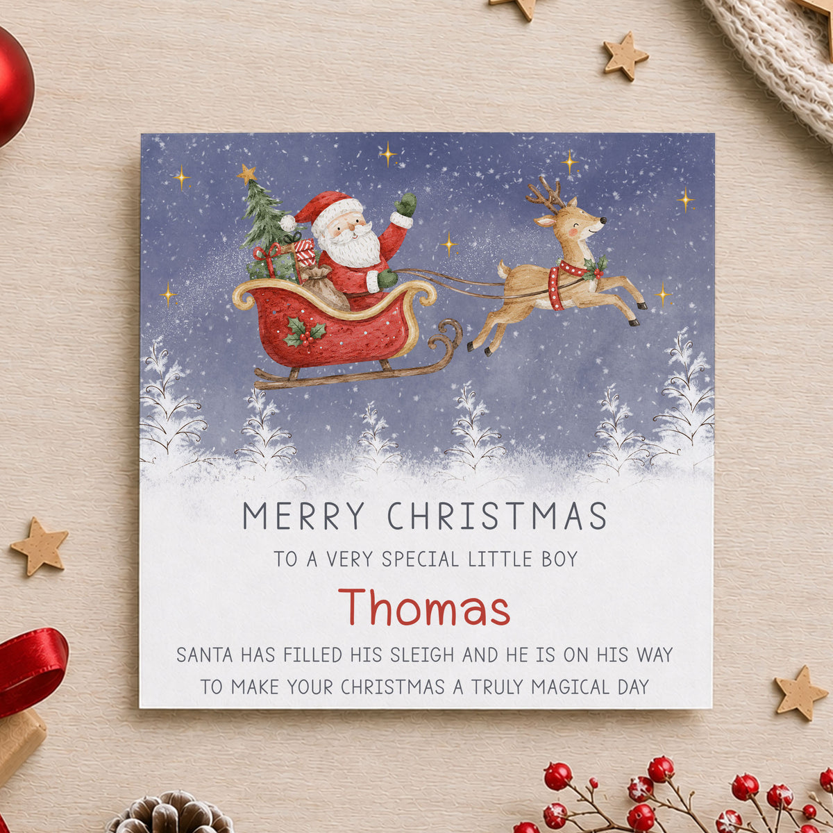 Personalised children’s Christmas card featuring Santa in a red sleigh with his reindeer flying over a snowy winter scene, personalised with any relation and child’s name.
