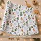 Personalised dinosaur Christmas wrapping paper featuring festive dinosaurs, Christmas trees, presents and stars, customised with a child's name.