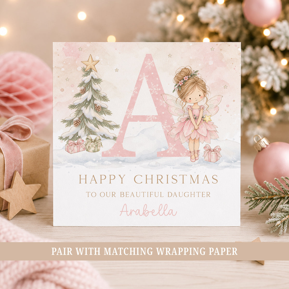 Personalised Christmas card for Daughter featuring a pink fairy, large initial, snowy Christmas tree and presents.