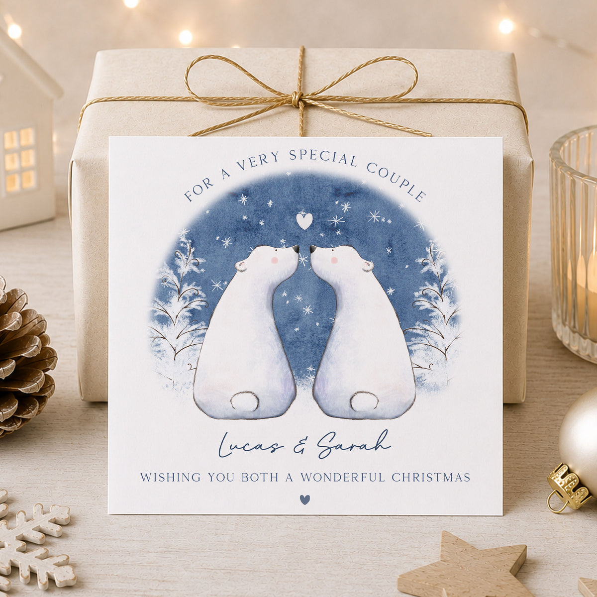 Personalised Christmas card for couples featuring two white polar bears together in a blue snowy winter scene with snowflakes and a heart, personalised with both names and your choice of relation.