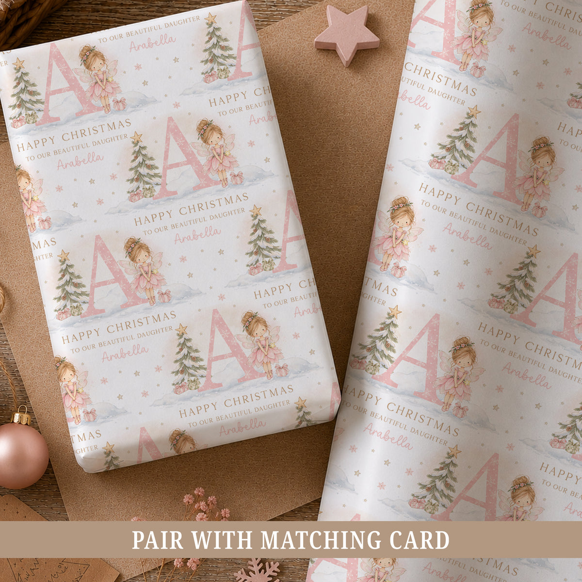 Personalised Christmas wrapping paper for Daughter featuring a pink fairy, large initial, snowy Christmas tree and personalised wording.