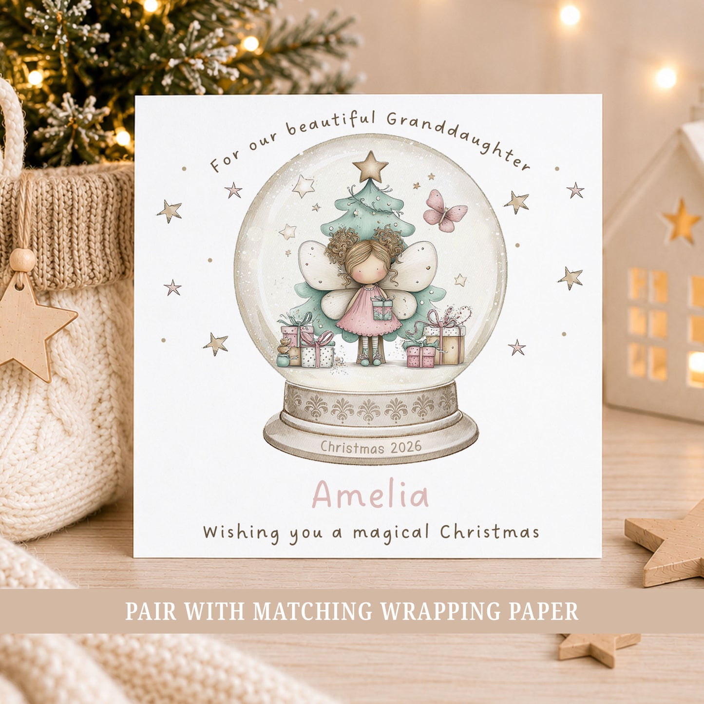 Personalised fairy Christmas card featuring a pink fairy inside a festive snow globe with Christmas tree, presents and stars, personalised with a name and relation.
