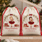 Personalised Christmas sack for girls featuring a ballerina in a red dress holding a little reindeer, surrounded by Christmas greenery, hanging gold stars and wrapped presents. Personalised with her name beneath the Merry Christmas wording, with 8 different ballerina characters available to choose from.