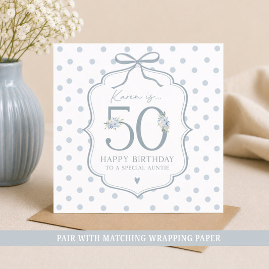 Personalised 50th birthday floral number wrapping paper with blue polka dot background and personalised name.