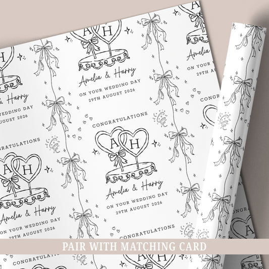 Personalised wedding wrapping paper featuring a black and white wedding cake design, customised with the couple's names and wedding date.