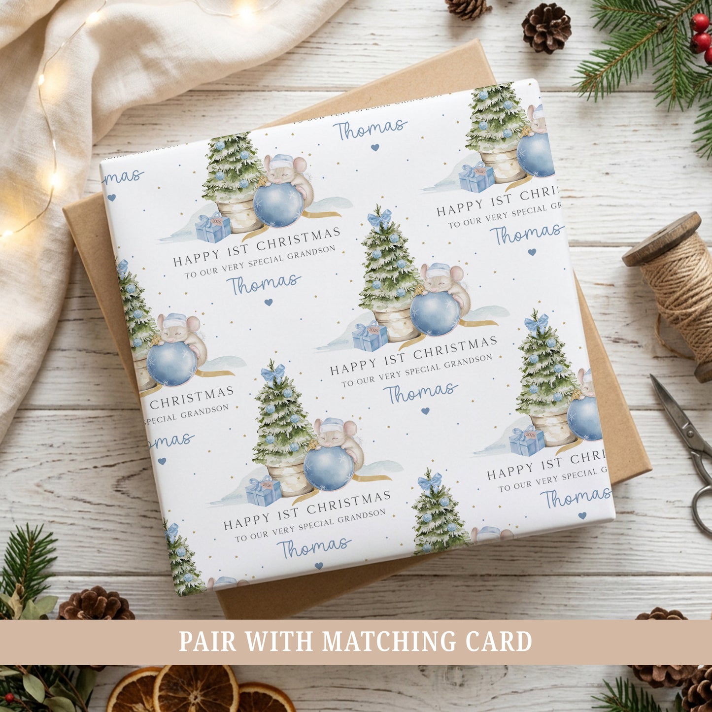 Personalised Baby’s First Christmas wrapping paper featuring a blue Christmas tree, cute mouse and bauble, personalised with the child’s name.