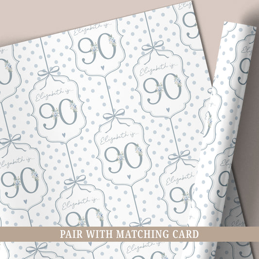 Personalised 90th birthday floral number wrapping paper with blue polka dot background and personalised name.