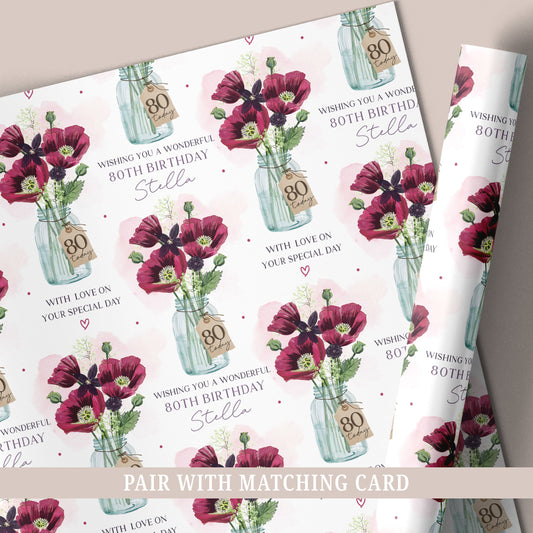 Personalised 80th birthday wrapping paper featuring a floral bouquet in a glass jar, customised with a name.