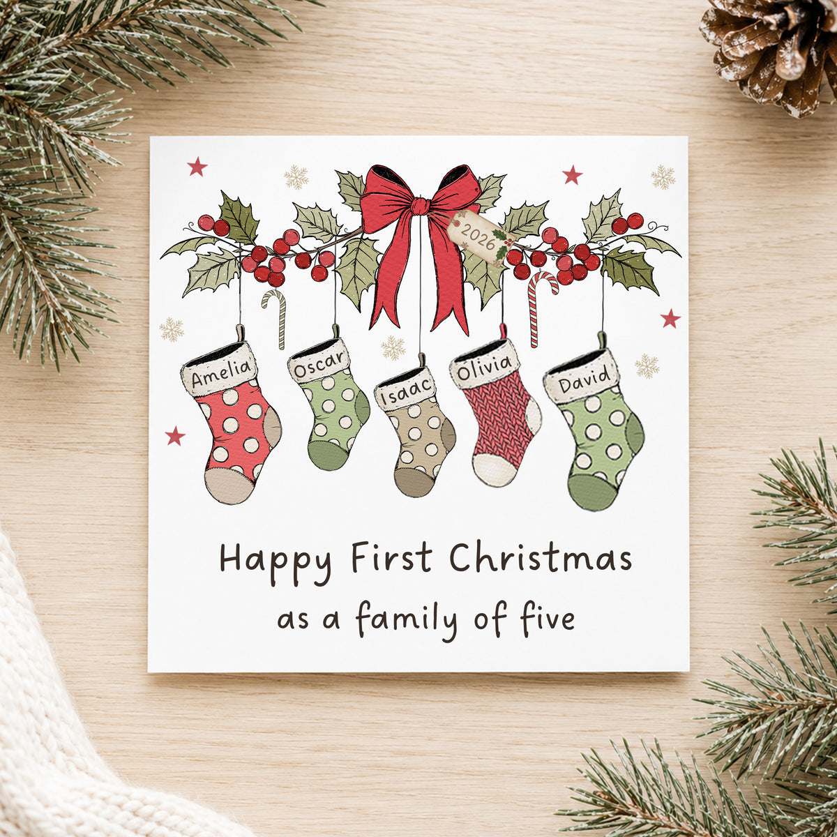Personalised First Christmas as a family card with named Christmas stockings, available for a new family of three, four, five or six.
