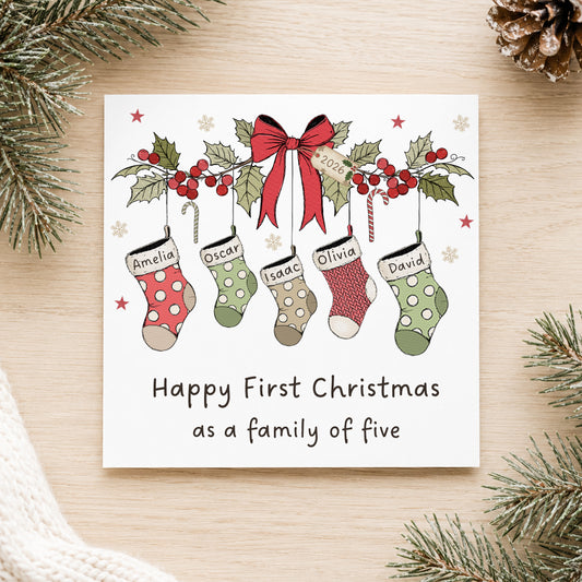 Personalised First Christmas as a family card with named Christmas stockings, available for a new family of three, four, five or six.
