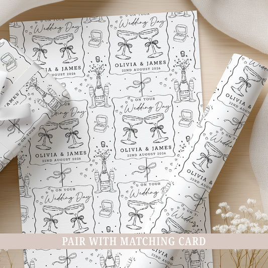 Personalised wedding wrapping paper featuring champagne glasses, names and wedding date