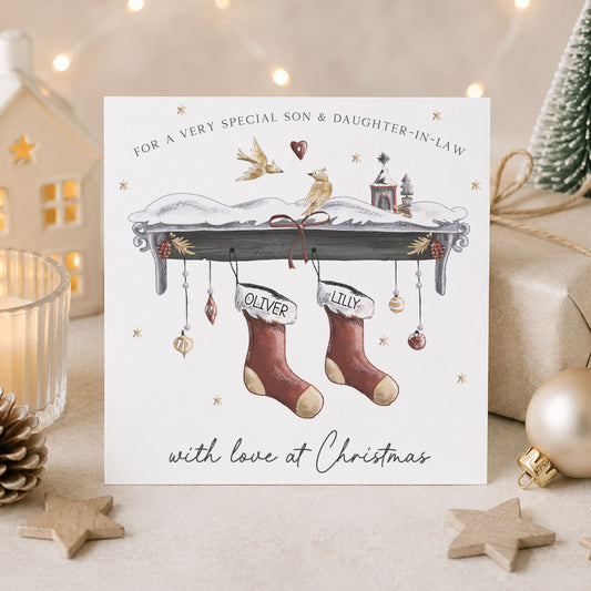 Personalised Christmas card for couples featuring two red festive stockings with names, snowy mantel, Christmas decorations and birds, available for Son and Daughter-in-Law, Daughter and Son-in-Law and other relations.