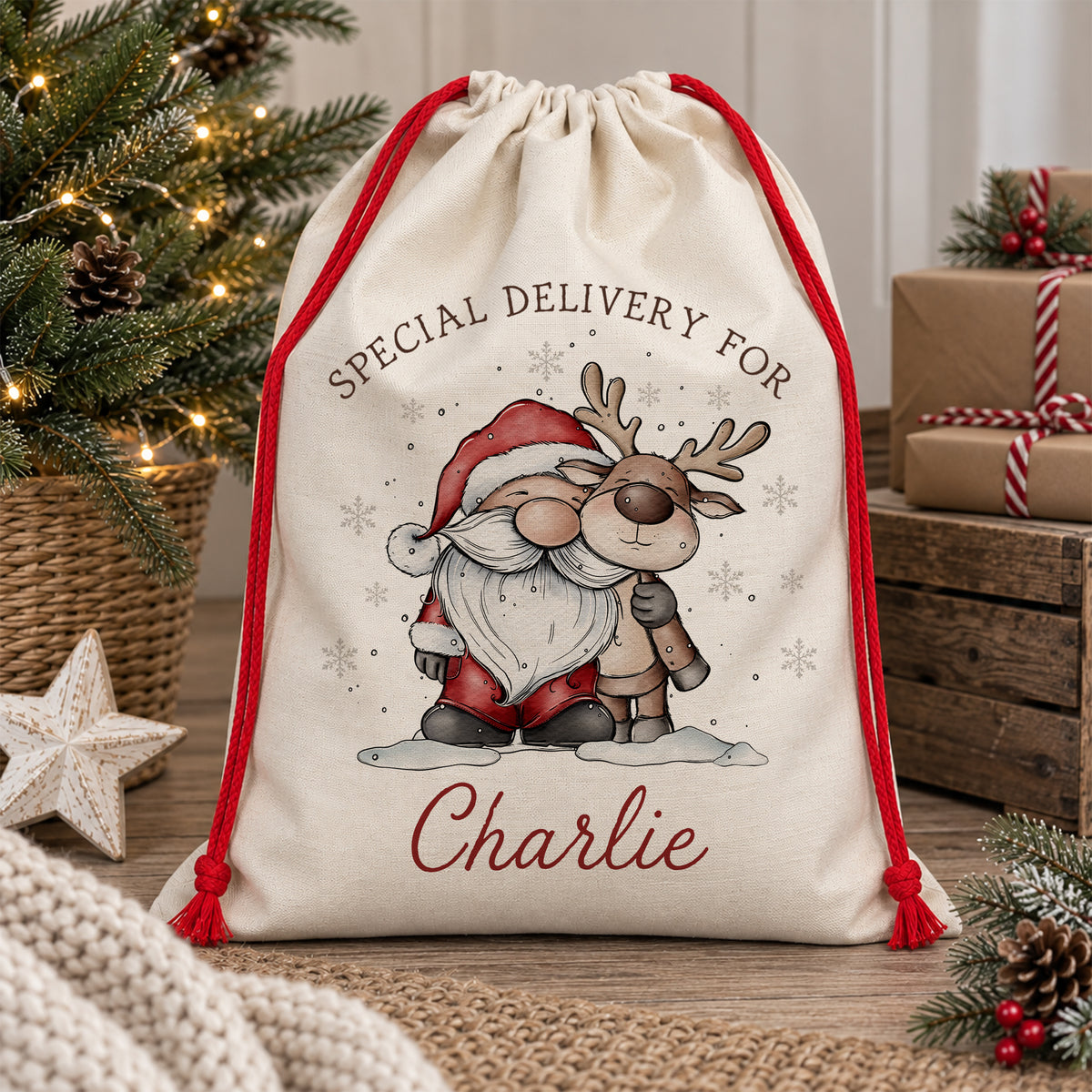 Personalised Christmas sack featuring a hand-drawn Santa and reindeer together in the snow, with “Special Delivery For” above and the child's name printed underneath. Natural poly linen Santa sack with a red drawstring, available in two sizes for children.