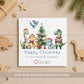 Personalised dinosaur Christmas card featuring festive dinosaurs in Santa hats around a Christmas tree, customised with name and relation.