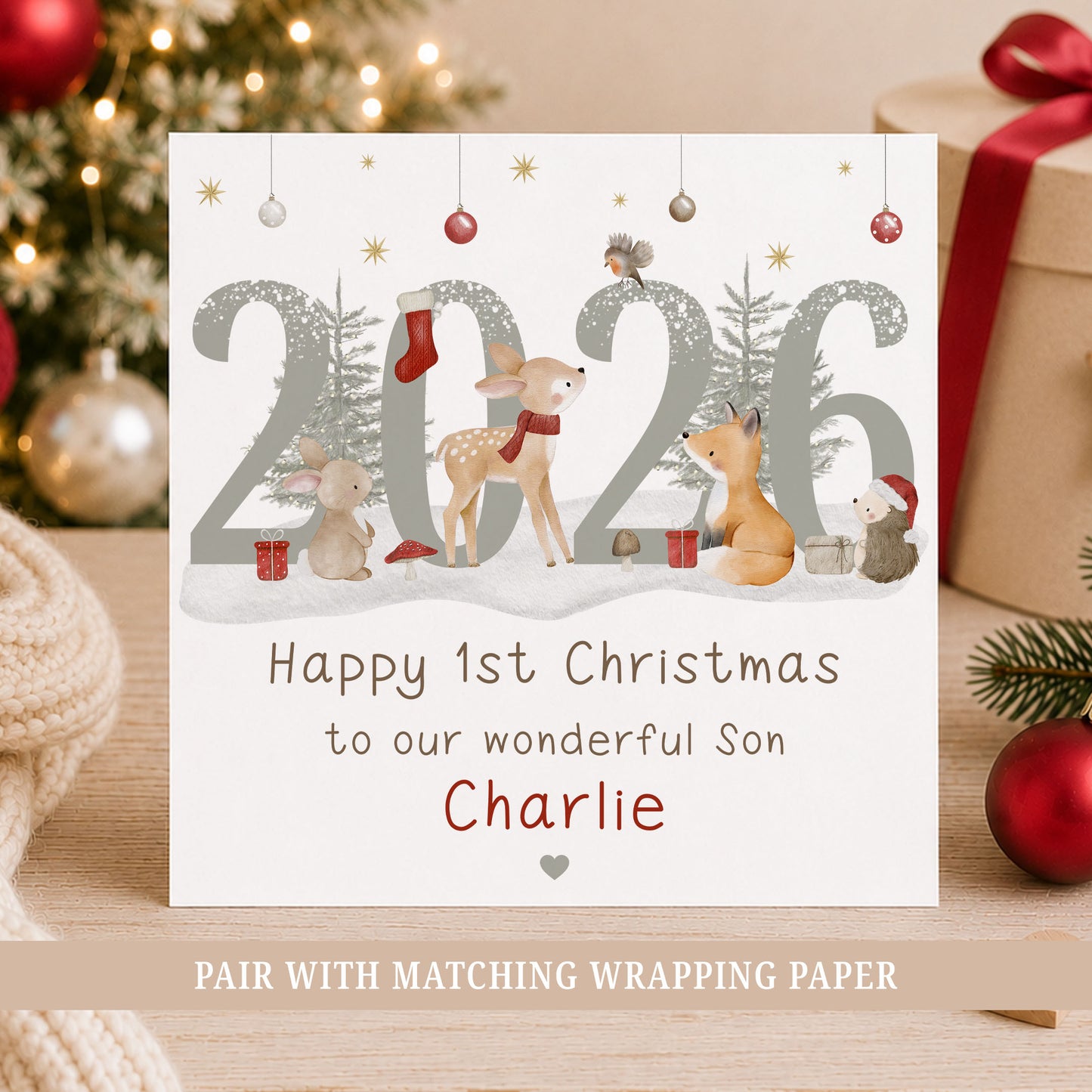 Personalised Son First Christmas card featuring woodland animals, 2026 design and the child’s name, with deer, bunny, fox and hedgehog illustrations.