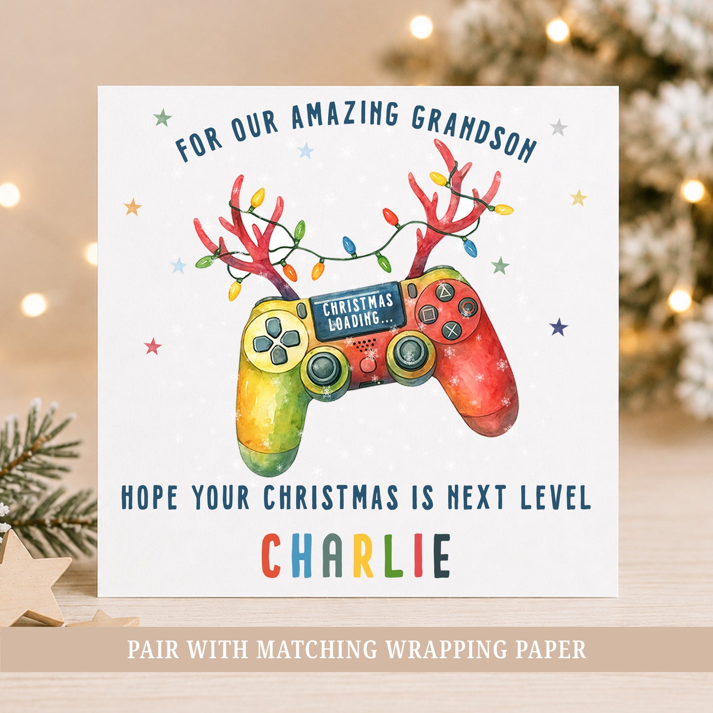 Colourful personalised gamer Christmas card featuring a festive games controller with reindeer antlers, Christmas lights and the recipient's name.