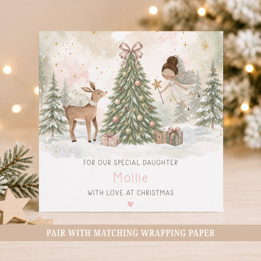 Personalised fairy Christmas card for girls featuring a hand-painted fairy, deer, decorated Christmas tree, presents and snowy woodland scene, personalised with a name and relation for Daughter, Granddaughter, Niece or Goddaughter.