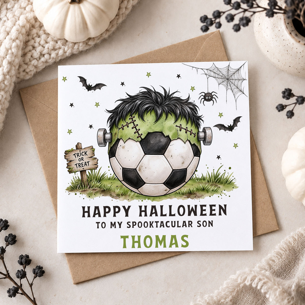Personalised Son Halloween card featuring a black and white football with a green Frankenstein monster head, black hair and bolts, surrounded by bats, stars, spider web and a Trick or Treat sign. Personalised with any name and relation including Son, Grandson, Nephew, Godson and Little Boy.