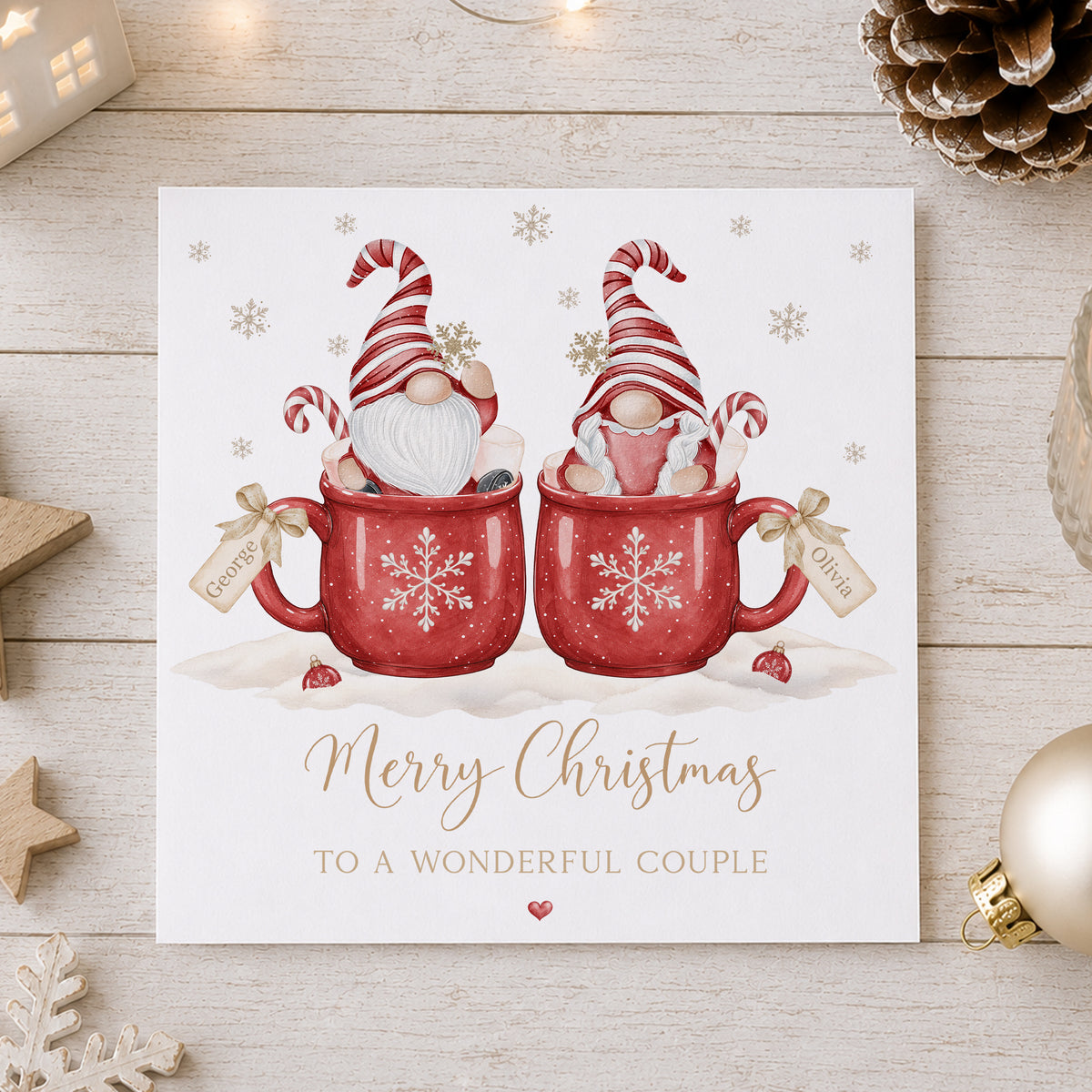 Personalised couple Christmas card featuring two Christmas gnomes in red snowflake mugs with candy canes and individual name tags, customised with two names and your chosen relation wording for couples including Daughter and Boyfriend, Son and Girlfriend, Brother and Sister-in-Law, same-sex couples and more.