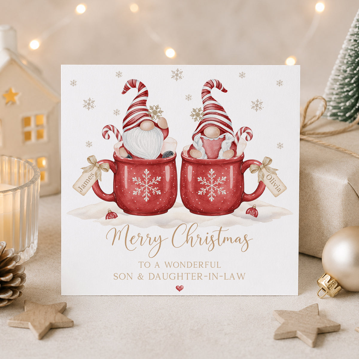 Personalised Christmas card for Son and Daughter-in-Law featuring a festive gnome couple in red Christmas mugs with personalised name tags.